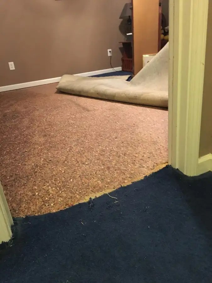 Carpet pad removal revealing water damage during Water Mitigation Services in South Lakes